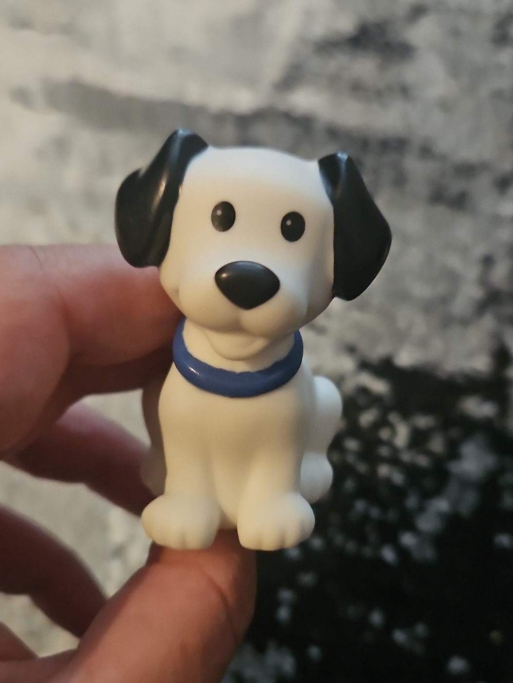 Fisher-Price Little People white dog figure with black ears and a blue collar.